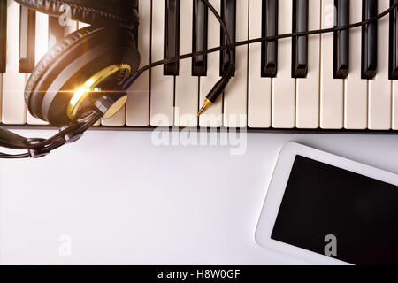 Electronic piano with headphones and tablet for musical composition. Horizontal Composition.Top view Stock Photo