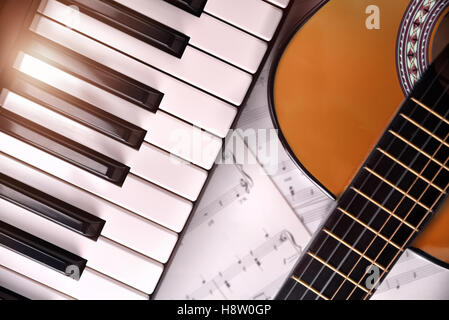 Piano and guitar with shine and sheet music background. Horizontal Composition.Top view Stock Photo
