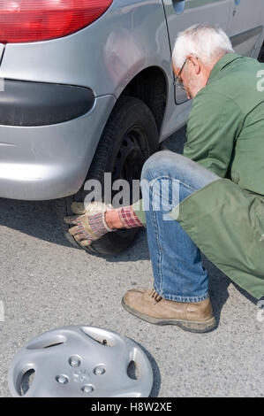 Senior, 60 +, changing tires Stock Photo
