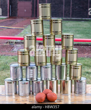 Cans, empty tin cans, built to a pyramid, at a children's party, throwing balls, Stock Photo