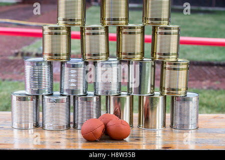 Cans, empty tin cans, built to a pyramid, at a children's party, throwing balls, Stock Photo