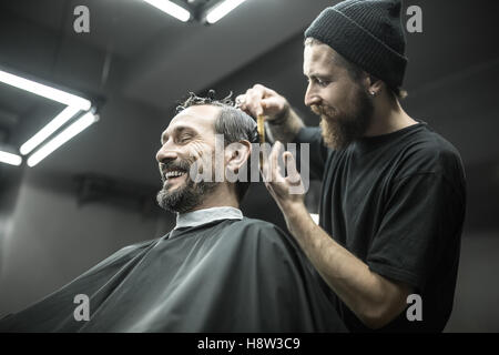 Cutting hair in barbershop Stock Photo - Alamy