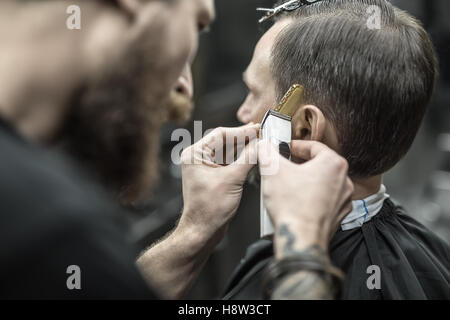Doing haircut in barbershop Stock Photo