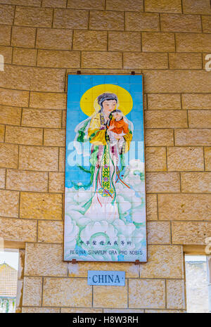 The glazed tiles of Madonna and the child is a gift from China, that located in the arcade of the Basilica of Annunciation Stock Photo