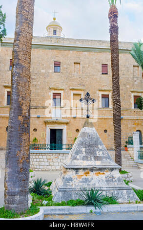 The small pyramid-shaped memorial stone, with an iron cross on the top, located in front of the Stella Maris Monastery, Haifa Stock Photo
