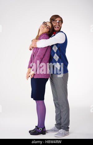 Man geek giving big hug to his girlfriend Stock Photo