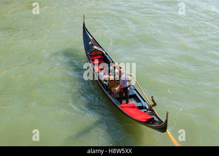 Gondola in Venice with holiday makers on board, photographed from above Stock Photo
