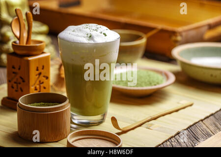 Still life with Japanese matcha accessories and matcha tea latte in glass Stock Photo