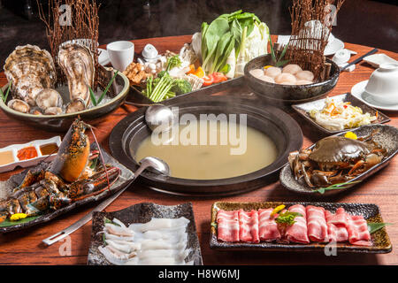 Full table of raw seafood for hot pot Stock Photo