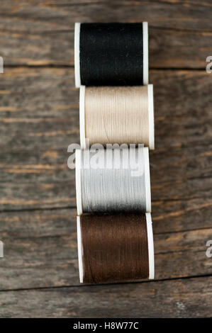 Multi-colored threads on a wooden table Stock Photo