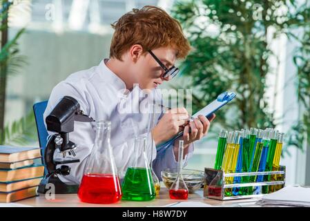 Young crazy chemist working in the lab Stock Photo