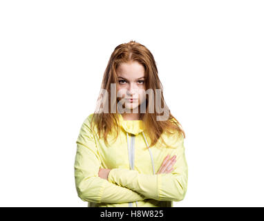 Teenage girl in yellow running jacket. Studio shot, isolated. Stock Photo