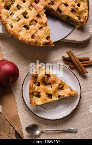 fresh baked apple pie slice on rustic table setting Stock Photo