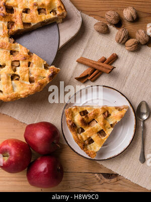fresh baked apple pie slice on rustic table setting Stock Photo