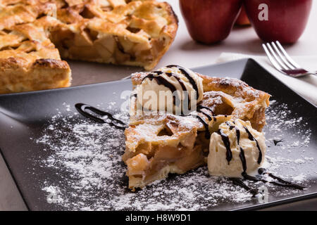 fresh baked apple pie slice with icecream on black plate Stock Photo