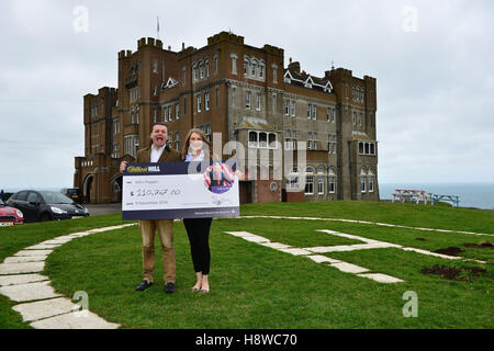 John Mappin, owner of the Camelot Castle Hotel in Tintagel, Cornwall, with his wife Irina and a cheque for &pound;100,000 he received from William Hill after placing a string of bets on Donald Trump becoming US president. Stock Photo