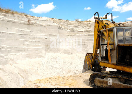 Old yellow dredge in sandy to career Stock Photo