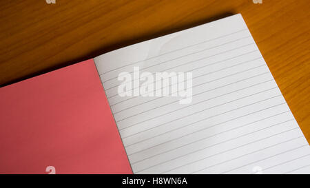 closeup of open notebook on wooden table Stock Photo
