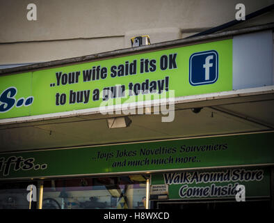 YOUR WIFE SAID ITS OK TO BUY A GUN TODAY sign on shopfront Stock Photo