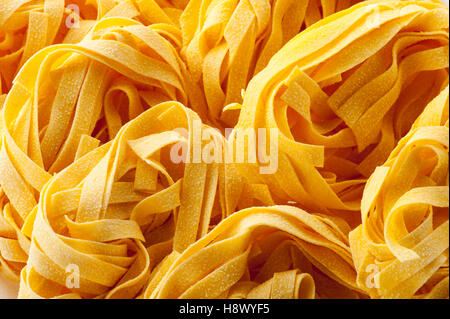 Close up of Italian tagliatelle pasta noodles in a full frame view for food or nutritional concepts Stock Photo