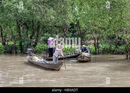 women rowing sampan boats on the Mekong River in Cai Be, Mekong Delta, Vietnam, Asia Stock Photo