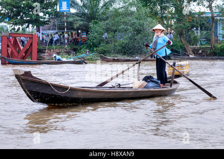woman rowing sampan boats on the Mekong River in Cai Be, Mekong Delta, Vietnam, Asia Stock Photo