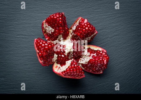 Fresh pomegranate seeds over black background Stock Photo