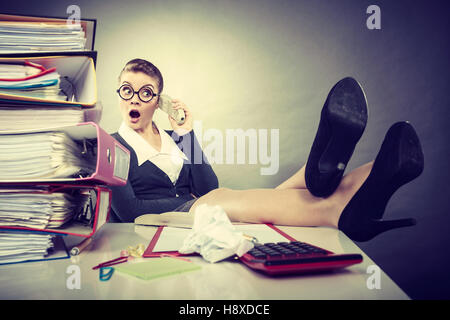 Responsibilities at work concept. Young elegant relaxed woman secretary making phone call. Lovely businesswoman using traditional telephone. Stock Photo