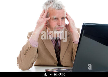 Elderly, overstrained businessman using laptop Stock Photo