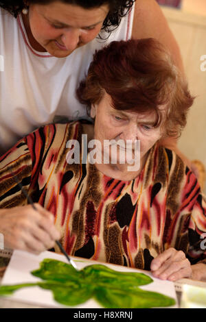 Elderly woman, occupational therapy, nursing home Stock Photo