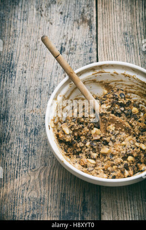 Christmas pudding mixture in a bowl with a wooden spoon. Stir up sunday Stock Photo