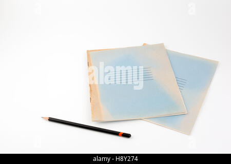 Old notebooks and black pencil - Free place for text. Stock Photo