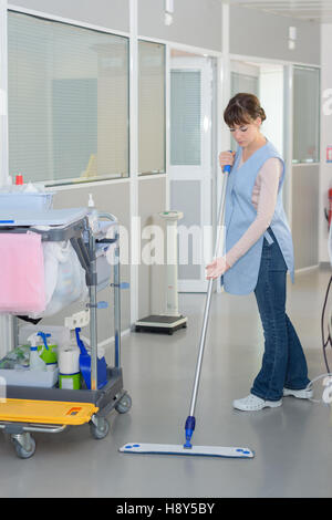 cleaner with mop and uniform cleaning hospital hall Stock Photo - Alamy