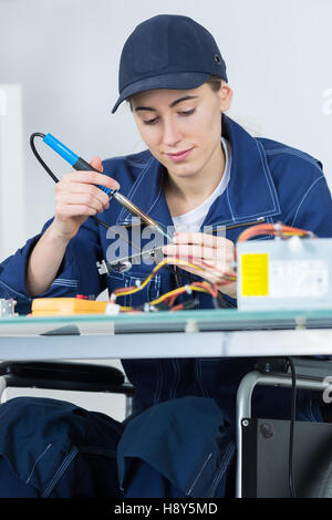 female technician working on an electronic circuit Stock Photo