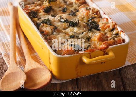 Strata casserole with spinach, cheese and bread close up in a dish for baking. Horizontal Stock Photo