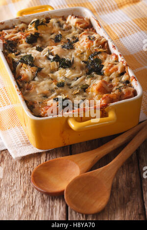 Strata casserole with spinach, cheese and bread close up in a dish for baking. vertical Stock Photo