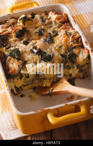 Strata casserole with spinach close up in baking dish. vertical Stock Photo