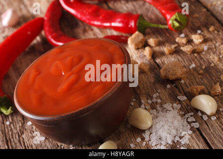 Red chilli sauce Sriracha with ingredients on the table. horizontal, macro Stock Photo