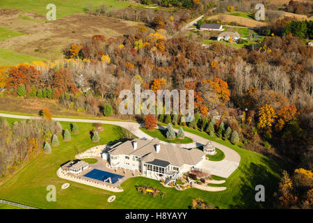 Aeriial photograph of a large, rural home with a swimming pool in Wisconsin on a beautiful autumn day. Stock Photo
