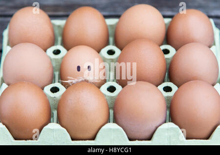 Single egg with moustache made out of chicken feathers. Stock Photo