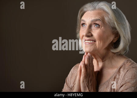 Senior woman praying Stock Photo