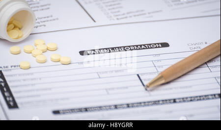 Close-up of patient information concept,medicine and pen on patient form on the desk. Stock Photo