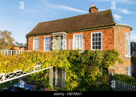 Unusual house accessed by a creeper covered bridge in Hungerford, Berkshire, southern England Stock Photo