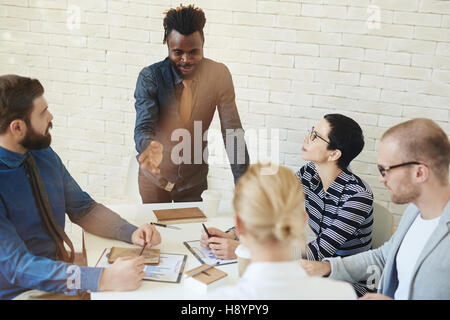 Competent specialist sharing his experience with colleagues Stock Photo