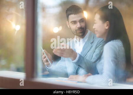 Two young traders discussing financial data Stock Photo