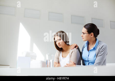Unhappy girl visiting her psychologist Stock Photo