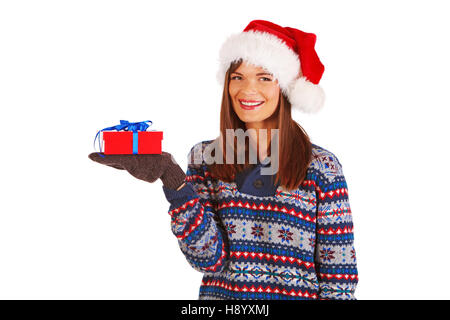 Pretty smiling girl in Santa's hat, holding christmas gift, looking at camera Stock Photo