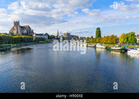 AUXERRE, FRANCE - OCTOBER 12, 2016: View of the Yonne River, with boats, the cathedral (Cathedrale Saint-Etienne), the Abbey of Saint-Germain, locals  Stock Photo