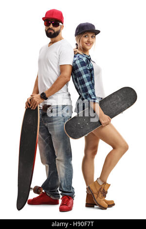 Full length portrait of a male and a female skater posing with a longboard and a skateboard isolated on white background Stock Photo