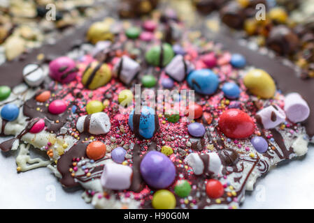 A selection of sweets and topping on chocolate slab. Stock Photo